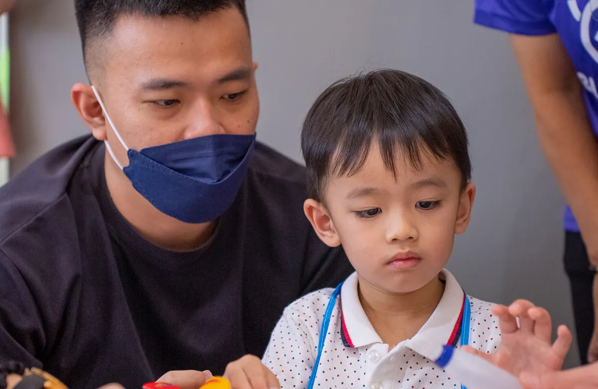 Teacher guiding a child during an activity