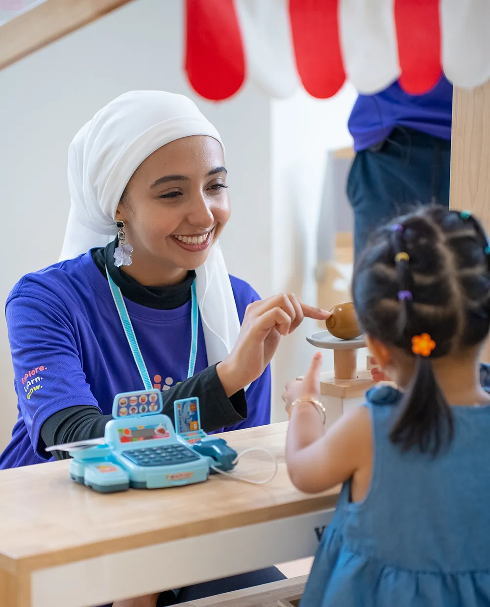 Teacher and child playing shop